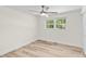 Bright bedroom featuring a ceiling fan, a large window, and light wood-look flooring at 306 2Nd Avenue Ne Pl, Conover, NC 28613