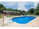A pristine in-ground swimming pool surrounded by a concrete patio at 306 2Nd Avenue Ne Pl, Conover, NC 28613