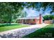 Classic brick ranch-style home with a long driveway and well-kept lawn at 306 2Nd Avenue Ne Pl, Conover, NC 28613