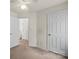 Bedroom boasts neutral paint and carpet, with two closets and ceiling fan at 3114 Pine Pointe St, Matthews, NC 28104
