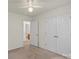 Bedroom features neutral carpet and paint with a ceiling fan and closet at 3114 Pine Pointe St, Matthews, NC 28104