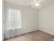 Neutral bedroom features a ceiling fan and natural light at 3114 Pine Pointe St, Matthews, NC 28104