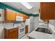 Functional kitchen with white appliances, warm wood cabinets, and ample counter space at 3114 Pine Pointe St, Matthews, NC 28104