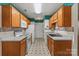 Functional kitchen with white appliances, warm wood cabinets, and ample counter space at 3114 Pine Pointe St, Matthews, NC 28104