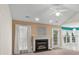 Bright living room featuring a fireplace, ceiling fan, and access to the outside patio at 3114 Pine Pointe St, Matthews, NC 28104