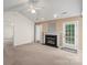 Cozy living room featuring a fireplace, ceiling fan, and access to the outside patio at 3114 Pine Pointe St, Matthews, NC 28104