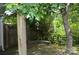 Well-maintained backyard features mature trees and a classic wood fence at 3136 Blueberry Dr, Monroe, NC 28110