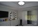 Bright bedroom featuring a vanity with a Hollywood-style lighted mirror and crown molding at 3136 Blueberry Dr, Monroe, NC 28110