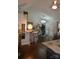 Inviting living room featuring hardwood floors, modern lighting, and an open floor plan to the kitchen and sliding glass doors at 3136 Blueberry Dr, Monroe, NC 28110