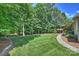 Spacious backyard with lush green grass, mature trees, and a cozy gazebo at 3284 Millstone Creek Rd, Lancaster, SC 29720
