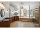 Luxurious bathroom featuring dual vanities, a soaking tub, and a glass shower at 3284 Millstone Creek Rd, Lancaster, SC 29720