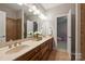 Primary bathroom with double vanity, framed mirrors, tile flooring, and shower at 3284 Millstone Creek Rd, Lancaster, SC 29720