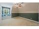 Bright bedroom features patterned accent wall, window seat, and a ceiling fan at 3284 Millstone Creek Rd, Lancaster, SC 29720