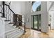 Welcoming foyer featuring hardwood floors, a grand staircase, and a decorative glass front door at 3284 Millstone Creek Rd, Lancaster, SC 29720