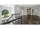 Foyer with chandelier over staircase with wood floors and black decorative metal bannister at 3284 Millstone Creek Rd, Lancaster, SC 29720