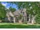 Beautiful stone-and-stucco home with manicured lawn, mature trees and covered front entry at 3284 Millstone Creek Rd, Lancaster, SC 29720