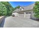 Spacious three-car garage with a wide driveway and well-manicured landscaping at 3284 Millstone Creek Rd, Lancaster, SC 29720
