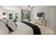 Bright main bedroom featuring a mounted TV, furniture with mirrored doors, and a sitting area at 3284 Millstone Creek Rd, Lancaster, SC 29720