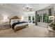 Spacious main bedroom featuring a sitting area, tray ceiling, fan, and lots of natural light at 3284 Millstone Creek Rd, Lancaster, SC 29720