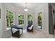 Cozy sitting area featuring upholstered chairs and a glass door to the outdoor space at 3284 Millstone Creek Rd, Lancaster, SC 29720