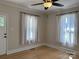 Cozy bedroom with two large windows, hardwood floors, and a ceiling fan at 339 Mayflower Ave, Cramerton, NC 28032