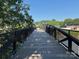 Picturesque walking bridge with black railings offering beautiful views of the surrounding landscape at 339 Mayflower Ave, Cramerton, NC 28032