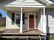 Cozy front porch with wooden planks and charming details around the front door at 339 Mayflower Ave, Cramerton, NC 28032