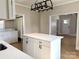 Well-lit kitchen featuring a center island, modern appliances, and adjacent laundry room at 339 Mayflower Ave, Cramerton, NC 28032