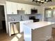 Contemporary kitchen with stainless steel appliances, white cabinets, and a center island at 339 Mayflower Ave, Cramerton, NC 28032