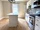 Bright kitchen with stainless steel appliances, island, and updated cabinets at 339 Mayflower Ave, Cramerton, NC 28032
