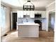 Modern kitchen features an island, stainless appliances, and stylish backsplash at 339 Mayflower Ave, Cramerton, NC 28032
