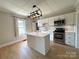 Modern kitchen features island, stainless appliances, and decorative lighting at 339 Mayflower Ave, Cramerton, NC 28032