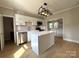 Updated kitchen features stainless appliances, island, and tiled backsplash at 339 Mayflower Ave, Cramerton, NC 28032