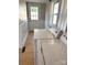 The laundry room shows a washer and dryer with light-colored paint and wood-look floors at 339 Mayflower Ave, Cramerton, NC 28032