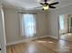 Bright living room with hardwood floors, ceiling fan, and natural light at 339 Mayflower Ave, Cramerton, NC 28032