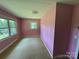 Quaint bedroom with two windows, carpeted floor, and neutral color scheme at 34393 Springdale Dr, New London, NC 28127