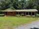 Charming brick home featuring a well-manicured lawn and a classic ranch-style design at 34393 Springdale Dr, New London, NC 28127