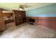Cozy living room with unique wood paneling, built-in bookshelves, and easy kitchen access at 34393 Springdale Dr, New London, NC 28127