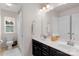 Bathroom with double sinks, a mirror, and a toilet and shower in view at 3701 Methodist Church Ln, Waxhaw, NC 28173