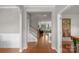 Elegant entryway showcasing gleaming hardwood floors, staircase, and an open view into the inviting living room and game room at 3701 Methodist Church Ln, Waxhaw, NC 28173