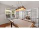 Spacious game room featuring a classic pool table, stylish lighting, and French doors leading to a bright dining area at 3701 Methodist Church Ln, Waxhaw, NC 28173