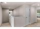 Bright hallway with carpet flooring, neutral paint, and access to bedrooms and storage on the second floor at 3701 Methodist Church Ln, Waxhaw, NC 28173