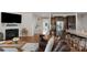 Open-concept living area boasts a fireplace, TV and flows seamlessly into the modern kitchen at 3701 Methodist Church Ln, Waxhaw, NC 28173