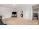 Open living space featuring a flat screen television and access to a bathroom at 3701 Methodist Church Ln, Waxhaw, NC 28173