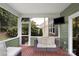 The cozy screened porch provides a shaded retreat and includes a TV for entertainment at 3701 Methodist Church Ln, Waxhaw, NC 28173