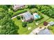 A stately brick home with a sprawling lawn, a sparkling pool, and mature trees creates a private oasis at 3706 Song Sparrow Dr, Matthews, NC 28104