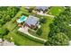A stately brick home with a sprawling lawn, sparkling pool, and mature landscaping creates a private oasis at 3706 Song Sparrow Dr, Matthews, NC 28104