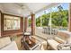 Inviting back porch features comfortable seating, a ceiling fan, and views of the backyard and pool area at 3706 Song Sparrow Dr, Matthews, NC 28104