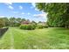 Sprawling backyard features lush lawn, mature trees, and established landscaping, perfect for outdoor enjoyment at 3706 Song Sparrow Dr, Matthews, NC 28104