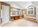 Expansive bathroom featuring a soaking tub, separate glass-enclosed shower, and abundant cabinet and counter space at 3706 Song Sparrow Dr, Matthews, NC 28104